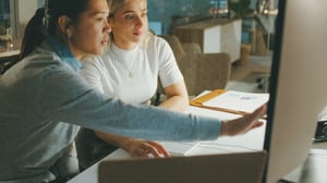 Two young women working at a computer