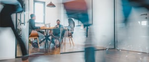 A small group sitting around a table in a conference room