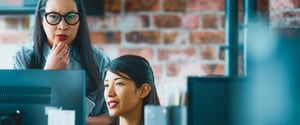 Two women working at a computer