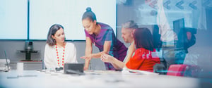 A group of coworkers discussing cost optimization