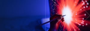 A digital pen touching a screen with a red burst of light in the center