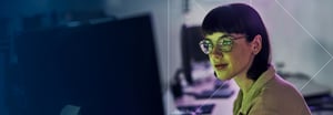 Woman in glasses working on a computer