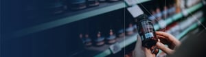 A close up of hands holding a bottle of over-the-counter medication, examining the label