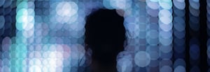 Abstract dark blue bokeh background with soft, overlapping circles of light in varying shades of blue and teal, creating a blurred, atmospheric effect