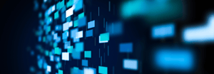 Abstract digital wall of glowing blue, teal, and white data blocks on a dark background, representing data flow or systems modernization.
